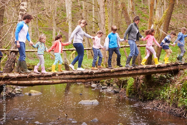 Obraz Adults With Children On Bridge At Outdoor Activity Centre