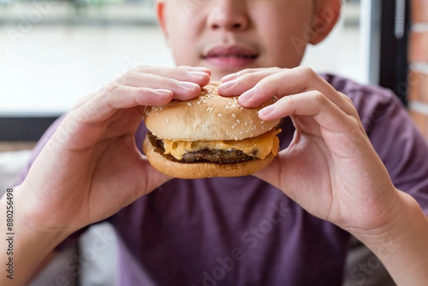 Obraz person eating hamburger