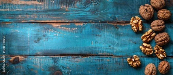 Fototapeta Blue wooden table with walnuts, providing a copy space image.