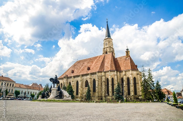 Obraz Cluj Napoca Unirii Square with the medieval gothic St Michael Church and the statue of Matei Corvin or Matias Rex on a sunny summer day with a beautiful sky in Transylvania region of Romania