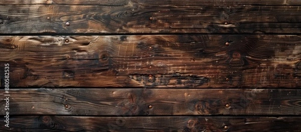 Fototapeta An old natural pattern on a dark wood texture background creates a rustic backdrop with copy space image potential