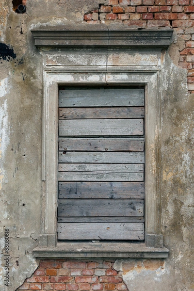 Fototapeta Old, boarded up window in the ruined wall of an old manor house in Poland.