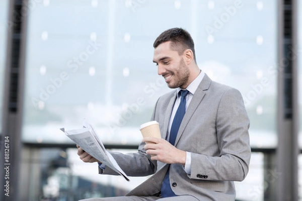 Obraz young businessman with coffee and newspaper