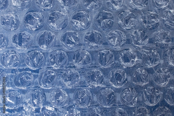 Obraz Bubble wrap plastic foil over deep blue background, flat lay close up abstract textured backdrop