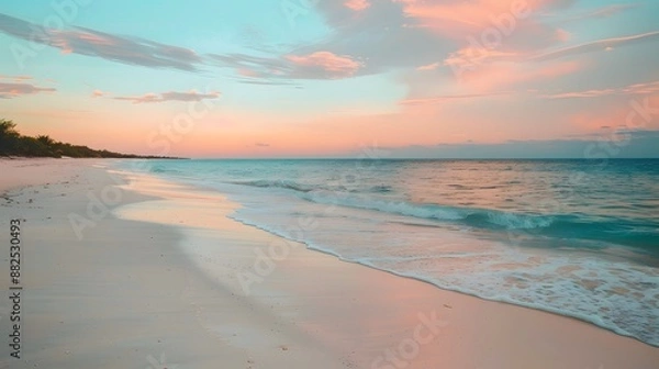 Fototapeta Summer background image of tropical beach with blurred horizon at sunset. Light sand of beach against backdrop of sparkling ocean water. Natural seascape. 