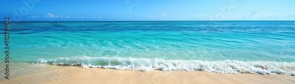 Fototapeta Gentle Waves Lapping at the Sandy Shore on a Bright Sunny Day