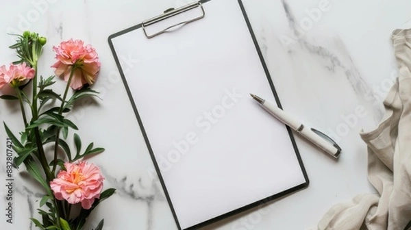 Fototapeta blank white paper on clipboard with pen and flower