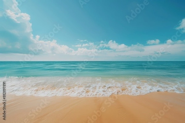 Obraz Gentle Waves Lapping at the Sandy Shore on a Bright Sunny Day