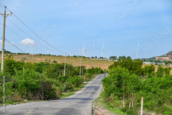 Obraz A road in central Vietnam surrounded by vast fields of wind turbines