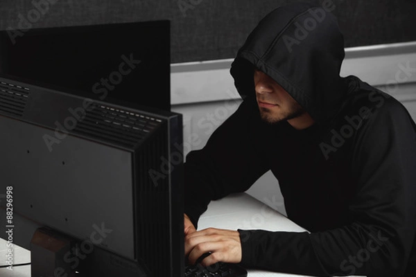 Fototapeta Hacker with computers in room