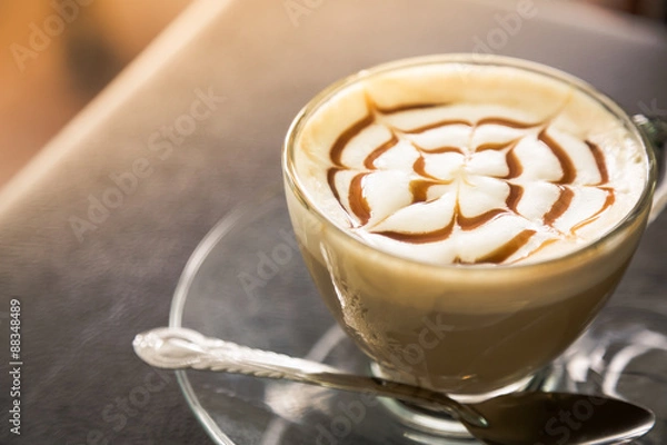 Fototapeta Hot latte art coffee on table ( Filtered image processed vintage