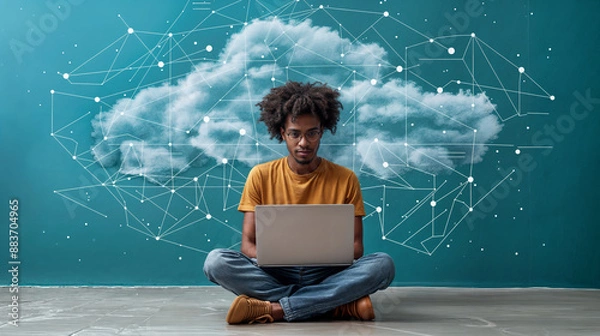 Obraz aerial view of a man sitting cross-legged and working at a laptop, with an abstract cloud and network lines in the background