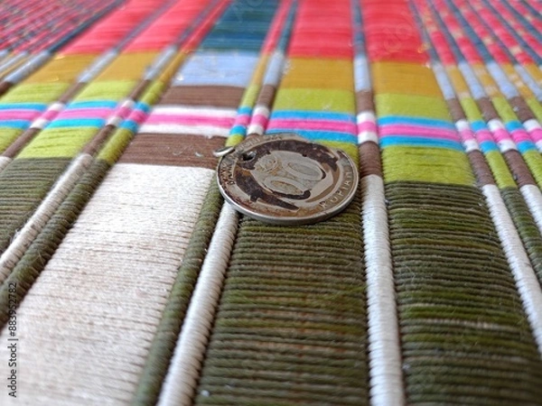 Obraz Coins on colored woven cloth