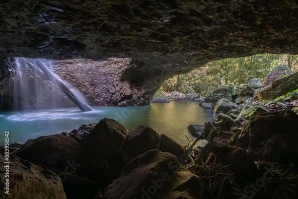 Obraz Inside the cave at Natural Bridge in Springbrook National Park, Australia. Waterfall falls through the roof of a cave.