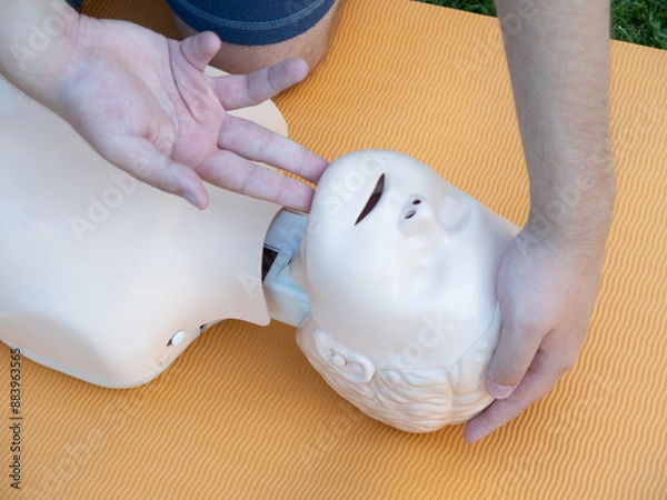 Fototapeta First aid training - mastering CPR techniques on a dummy