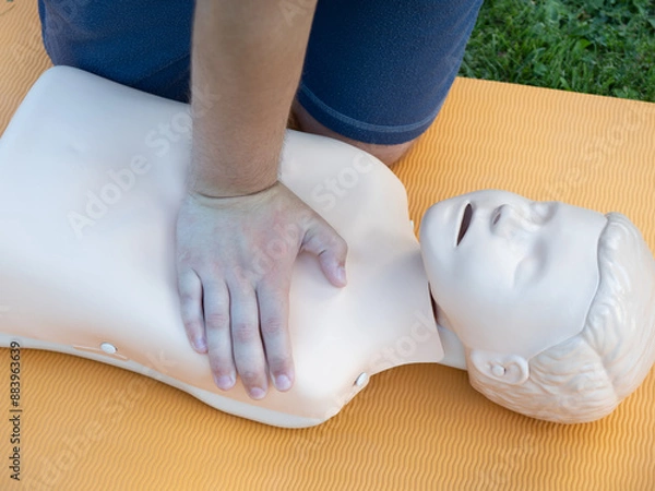 Fototapeta First aid training - mastering CPR techniques on a dummy