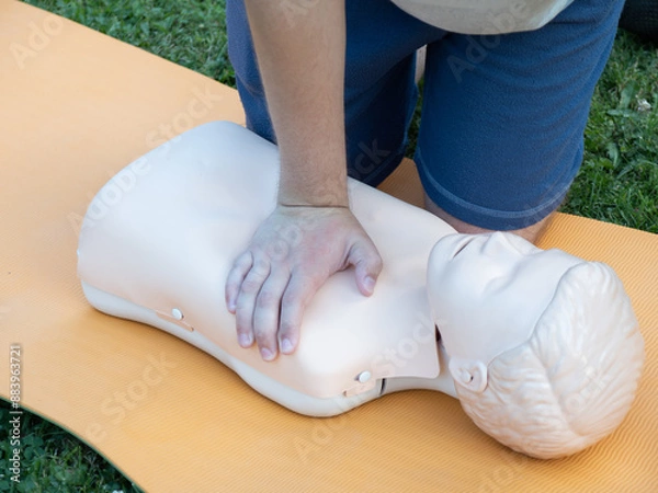 Fototapeta First aid training - mastering CPR techniques on a dummy