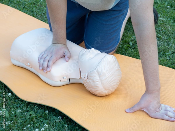 Fototapeta First aid training - mastering CPR techniques on a dummy