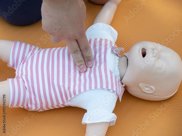 Fototapeta First aid training - mastering CPR techniques on a dummy