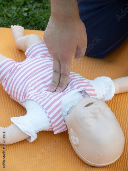Fototapeta First aid training - mastering CPR techniques on a dummy