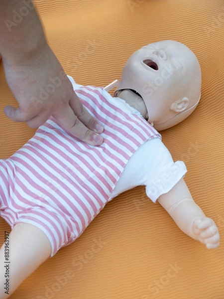 Fototapeta First aid training - mastering CPR techniques on a dummy