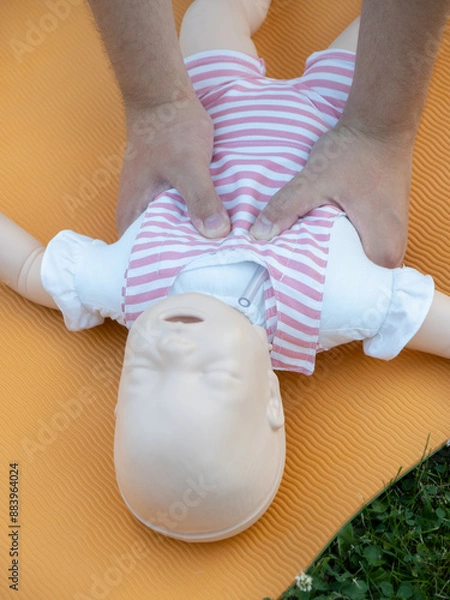 Fototapeta First aid training - mastering CPR techniques on a dummy