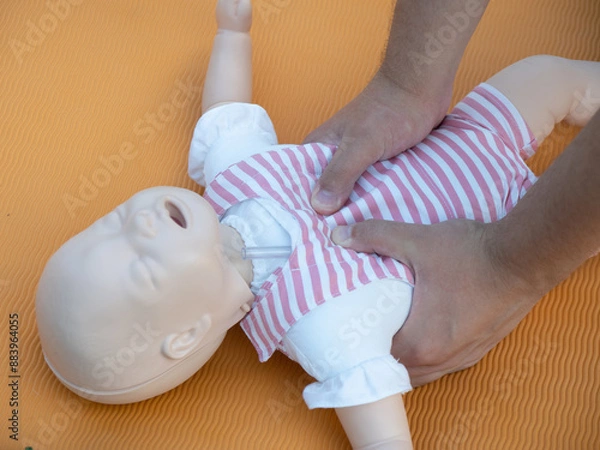 Fototapeta First aid training - mastering CPR techniques on a dummy