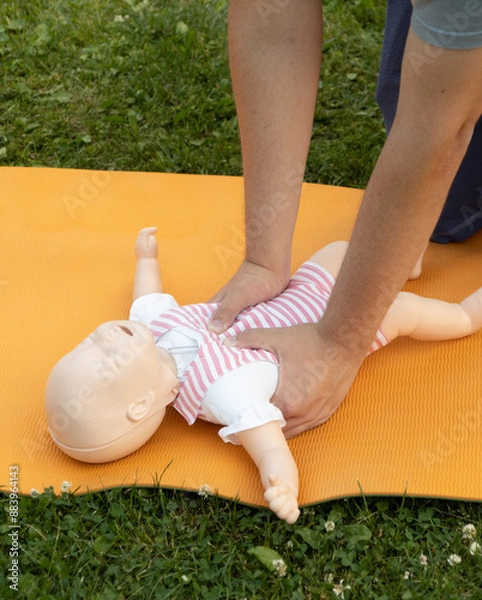Fototapeta First aid training - mastering CPR techniques on a dummy