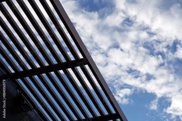 Fototapeta the view from below is a slatted roof and blue sky