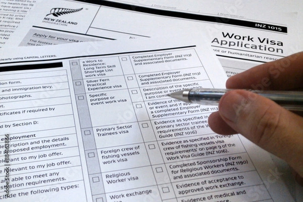 Fototapeta Man filling a New Zealander visa application form