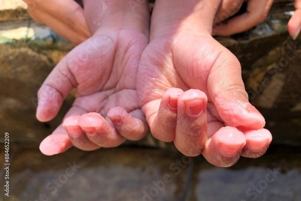 Fototapeta close up of child's fingers wrinkled in cold