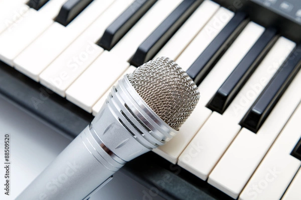 Fototapeta The microphone lies on the synthesizer keyboard