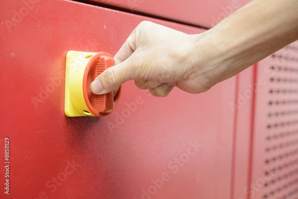 Fototapeta Hand turn on switch