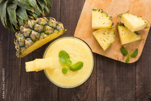 Obraz Pineapple smoothie with fresh pineapple on wooden table