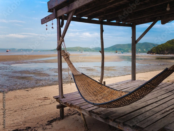 Fototapeta Dog is lie down and play on the beach in summer in Thailand.