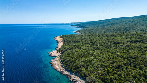 Fototapeta An aerial view of the Blue Lagoon at Plaža Krušćica and Tarej Beach on the island of Cres, showcasing their fantastic turquoise waters and surrounding islands. Boats dot the serene lagoon