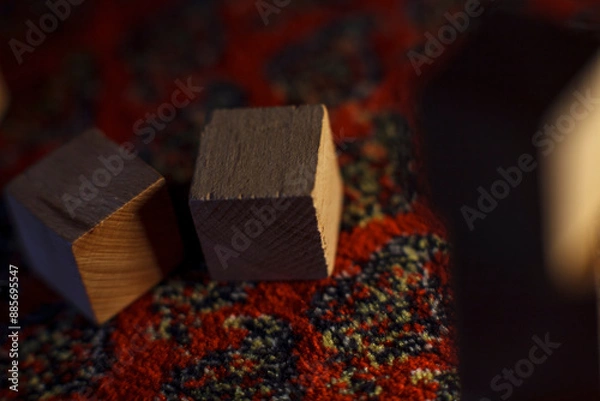 Fototapeta Wooden blocks on a colorful patterned surface