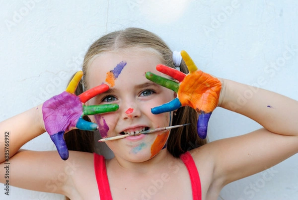 Obraz beautiful little girl artist in paints cheerful and funny mischievous