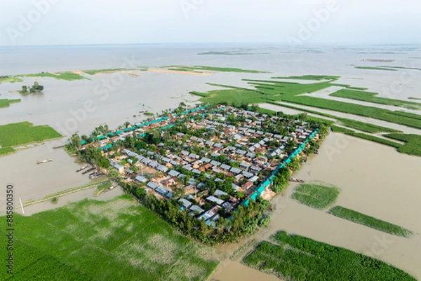 Obraz Aerial view showcasing the devastating impact of floods on villages in Northern Bangladesh, highlighting the submerged homes, affected communities, highlighting the severe impact and the resilience