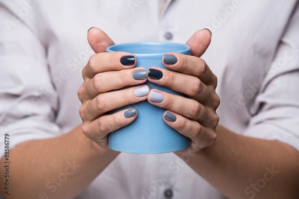 Fototapeta Female hands with blue cup