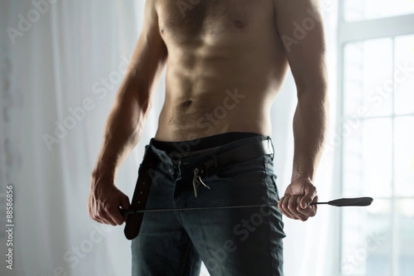 Obraz Handsome guy topless with whip BDSM