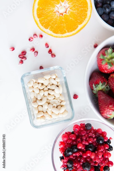 Fototapeta close up of fruits and berries in bowls on table