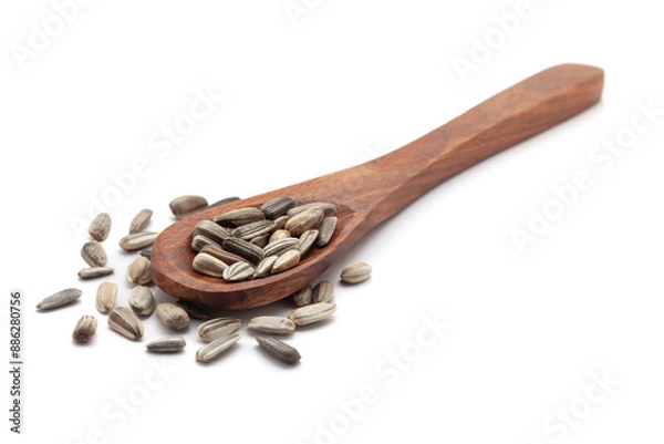 Fototapeta Front view of a wooden spoon filled with dry Organic Sunflower (Helianthus annuus) seeds. Isolated on a white background.