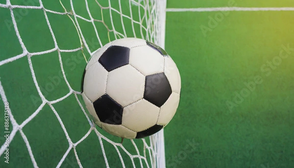 Fototapeta soccer ball in goal with green backgroung