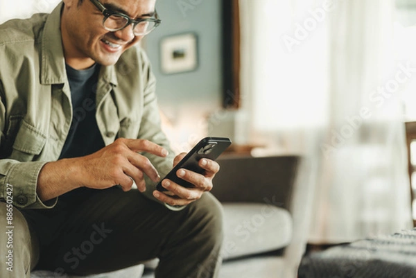 Fototapeta man using cell phone holding mobile texting message contact us.chatting,search internet shopping online.technology device communication connecting