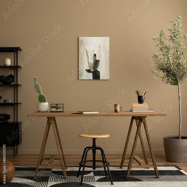 Fototapeta Creative composition of workplace interior with mock up poster frame, wooden desk, rattan chair, black rack, patterned rug, plant, brown wall, books and personal accessories. Home decor. Template.