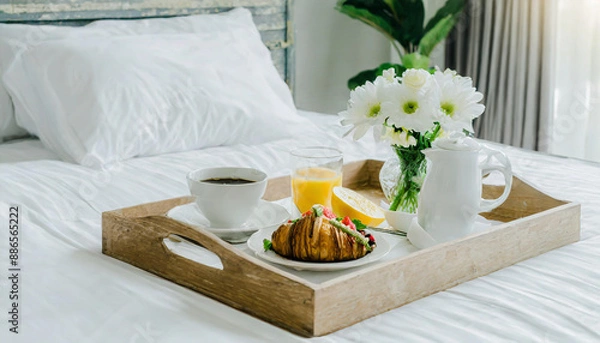 Fototapeta Wicker tray with continental breakfast on white bed sheets