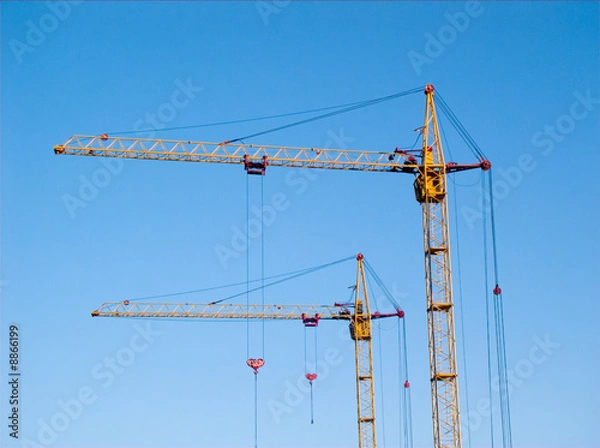 Fototapeta two tall yellow lifting cranes