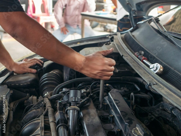 Fototapeta Close up Man hands fixing Car machinery vehicle mechanical service. Mechanic man hands repairing car auto repair shop. open vehicle hood checking up auto mobile. Vehicle Car maintenance engineer.