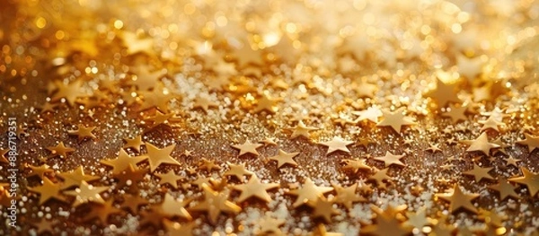 Obraz Background with golden star shaped sprinkles creating a festive backdrop with copy space image